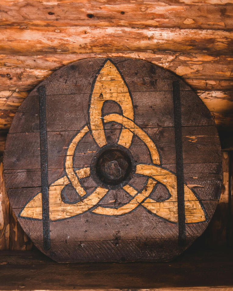 Cait Monroe logo Metallic C M with sword and celtic spirals